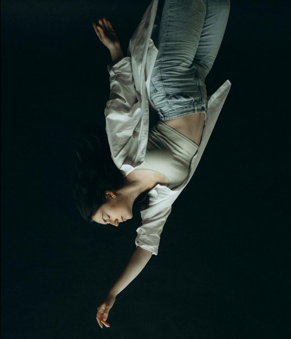 Woman in dynamic cardio pose with a calm expression.